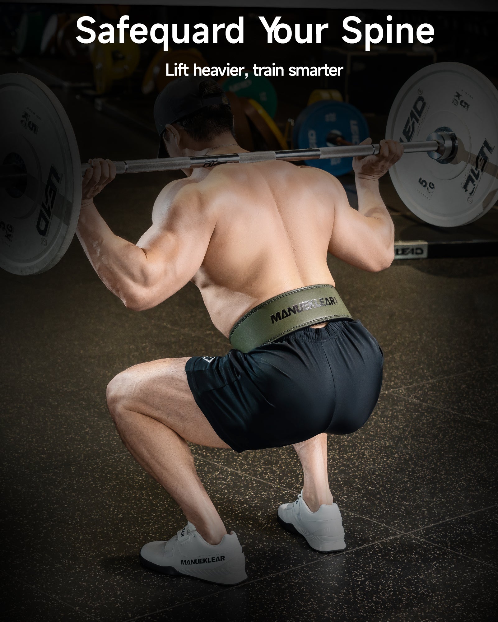 man squatting wearing green weight lifting belt